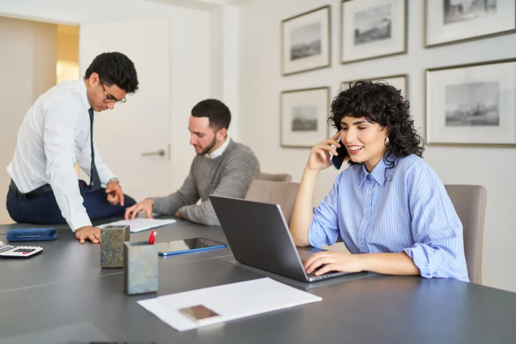 businesswoman talking on phone and working on lapt 2025 03 08 01 37 15 utc